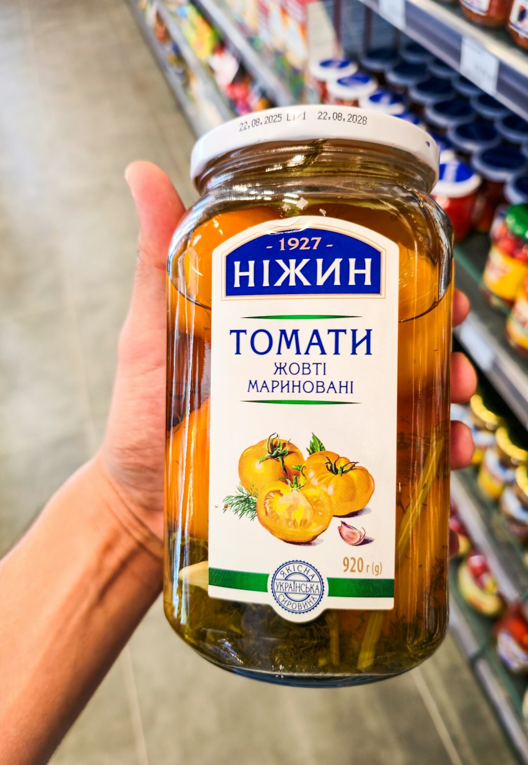 Glass jars with preserved vegetables on a shelf
